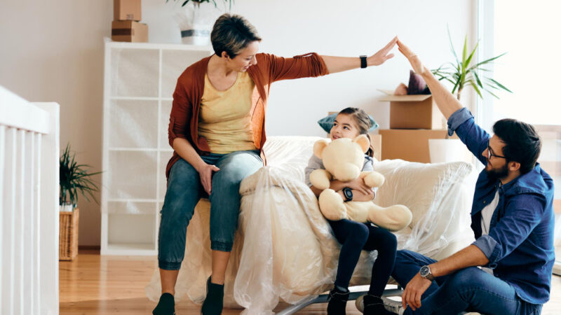Happy family having fun while moving into their new home