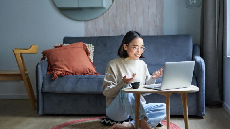 Portrait of young working woman korean girl studying on remote online talking to laptop video chat h