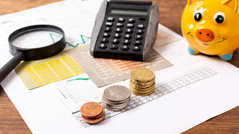 Front view of piggy bank and stationery items