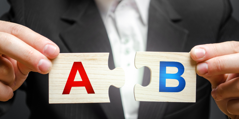 A man connects puzzles with the letters a and b. A/b test marketing research method.

