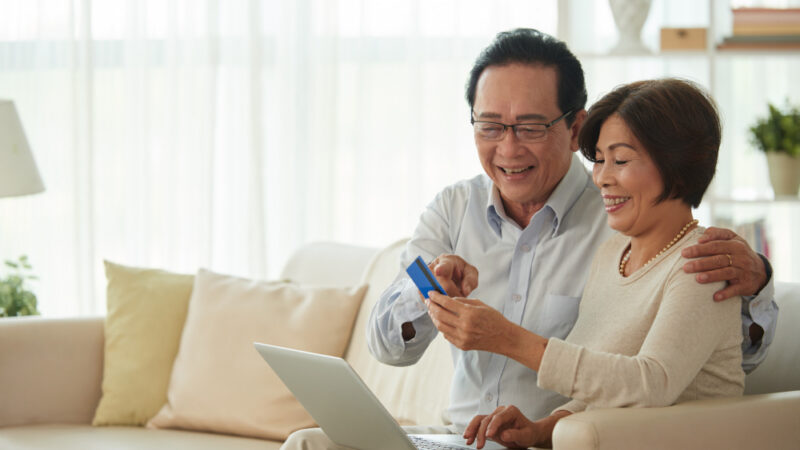 Middle-aged man and |woman doing online shopping