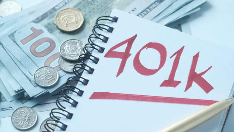 Notepad with word 401k on white table, close up ,