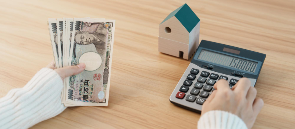 Woman counting japanese yen banknote with house model real estate home mortgage japan cash tax recession economy inflation investment finance and savings concepts
