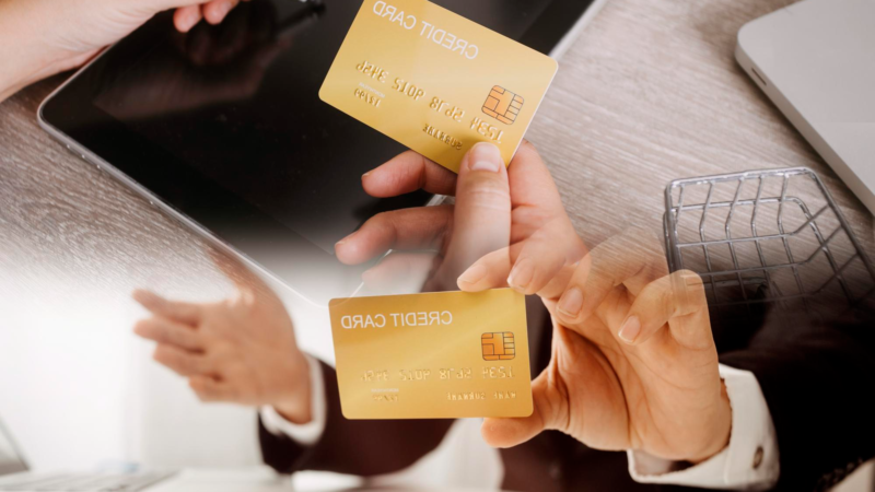 Hands holding credit card and using laptop online shopping
