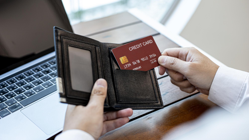 Men are pulling their credit cards out of their wallets